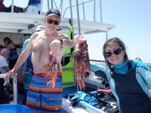 divers holding lionfish